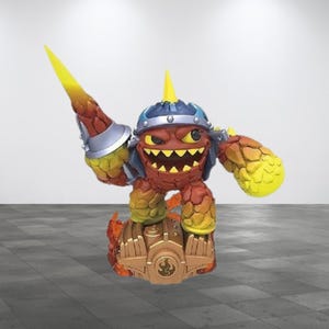 May include: A fiery orange and yellow figure with a spiked helmet and a sword, standing on a gold base with flames. The figure is a Skylanders character.