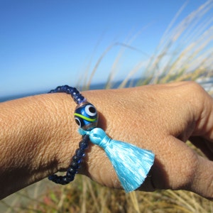 Aqua tassel bracelet, eye bead stretch bracelet with silky tassel, montana blue czech crystals, boho tassel jewelry