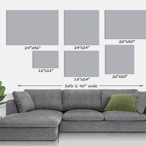 May include: A display of six gray rectangular wall art pieces of varying sizes, including 24"x36", 24"x24", 20"x30", 12"x18", 20"x20", and 18"x24". A gray sectional sofa is below the art. The sofa is 90 inches wide.