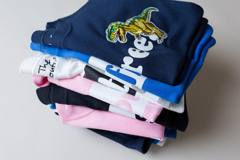 The Joyful Rebel collection of t-shirts - lots of colours, pale pink, navy blue, royal blue, black, white and grey.