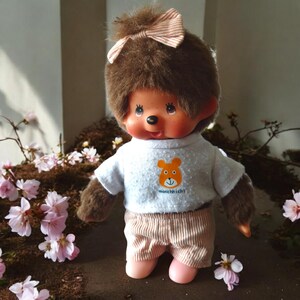 Monchhichi girl with Monchhichi t shirt  striped trousers and pink shoes vintage collectible toy 1980s