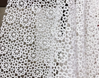 May include: White crochet lace fabric with a delicate circular pattern.