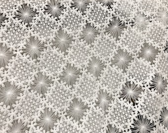 May include: White lace fabric with a delicate snowflake pattern.