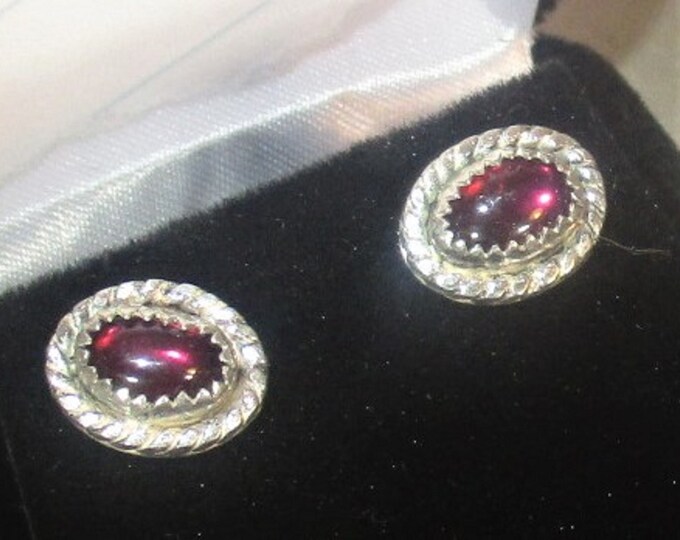 Genuine Mozambique garnets are set in handmade sterling silver stud earrings