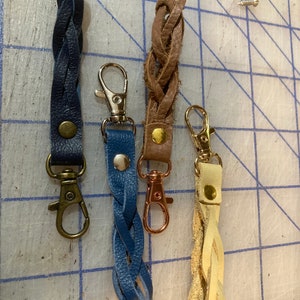 Leather zipper pull. Sturdy clasp, great for jackets, purses, or suitcases. Silver or gold clasps now available.