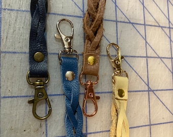 Leather zipper pull. Sturdy clasp, great for jackets, purses, or suitcases. Silver or gold clasps now available.