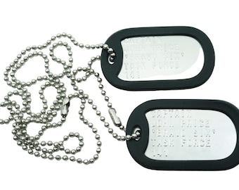 May include: Two silver dog tags with black rubber coating on a silver ball chain. The tags have engraved text.