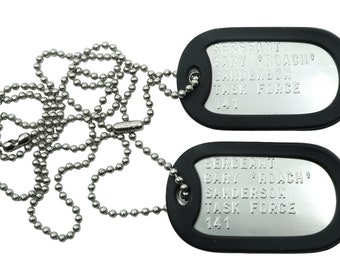 May include: Two silver military dog tags with black rubber coating on a silver ball chain. The tags read "SERGEANT GARY 'ROACH' SANDERSON TASK FORCE 141".