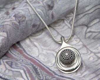 Silver Flute Necklace with an etched vintage black and white mosaic cabochon on a closed hole flute key. Cabochon hanging on snake chain.