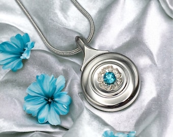 Engraved Flower with Aquamarine Swarovski Crystal on a real Plateau (closed hole) Flute Key hanging from a matching silver snake chain.