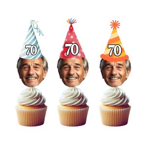 May include: Three cupcakes with white frosting and a face with a party hat on top. The hats are blue and white striped, red with white polka dots, and orange with white stripes. Each hat has the number 70 on it.