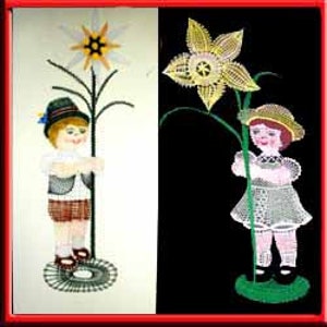 May include: A split image features two embroidered figures. On the left, a boy in traditional attire holds a star-shaped flower. On the right, a girl in a dress holds a daffodil. Both figures are on a circular base.