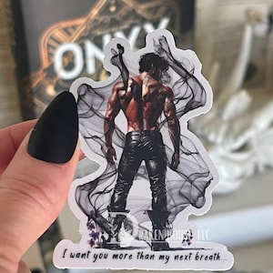 May include: A white sticker with a black and white illustration of a shirtless man with dark hair and a muscular build. He is wearing black pants and boots. The man is surrounded by black smoke. The text "I want you more than my next breath..." is at the bottom of the sticker.