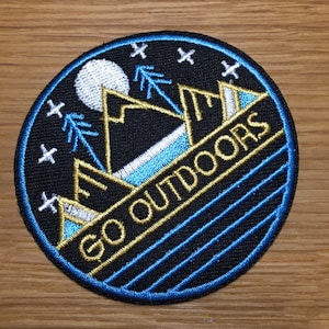 round GO OUTDOORS patch with mountains & trees - about 7 cm diameter - backpacking travel desert heat moon stars holiday hiking camping
