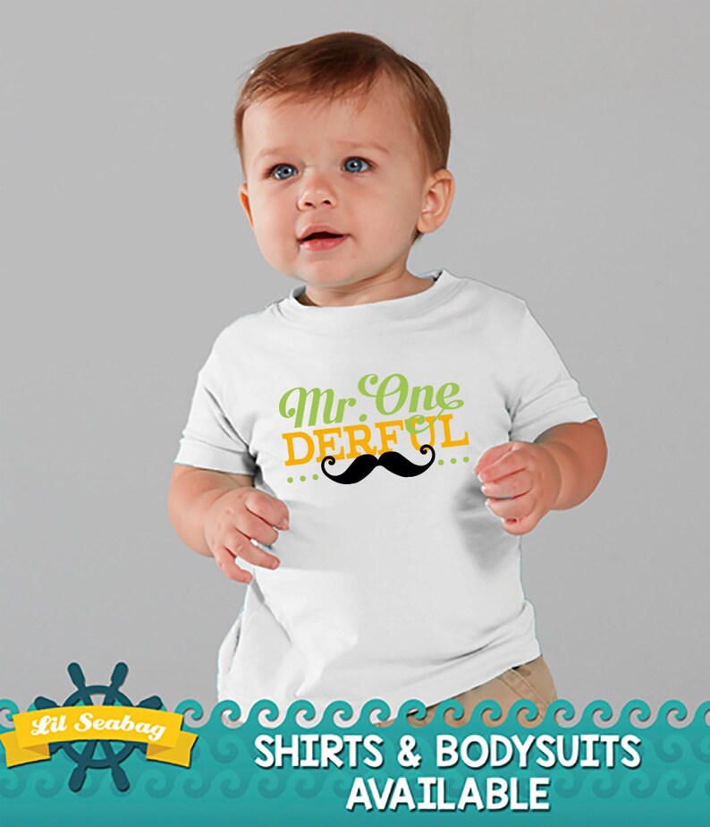 May include: White short-sleeved shirt with the text "Mr. One Derful" in green and orange lettering with a black mustache graphic. The shirt is available in both shirts and bodysuits.