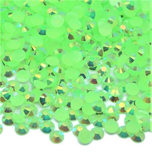 May include: A large quantity of small, round, neon green rhinestones. The rhinestones have a slightly iridescent finish.