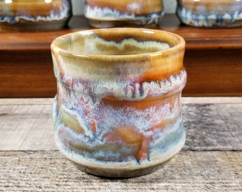 Wheel thrown spiral style tumbler with stunning drip glaze in shades of orange, green, blue, brown and white. Makes a great gift! 14 oz size