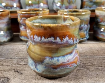 Wheel thrown spiral style tumbler with stunning drip glaze in shades of orange, green, blue, brown and white. Makes a great gift! 12 oz size