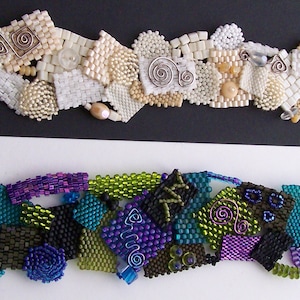 May include: Two beaded bracelets. The top bracelet features a mix of white, cream, and tan beads with silver wire accents. The bottom bracelet showcases a vibrant array of colors, including teal, purple, green, and black beads, with wire accents.