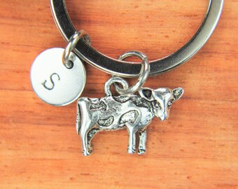 May include: Silver cow charm keychain with a silver initial charm that says "S".
