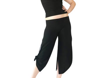 May include: A black halter top and black cropped pants with a tie detail at the bottom. The pants have a slit on the side.