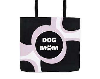 May include: Black and white tote bag with a pink circle in the center. The circle has the text "DOG MOM" with a paw print in the middle.