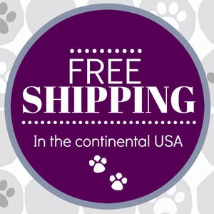 May include: Purple circle with white text that says "FREE SHIPPING" and "In the continental USA". The circle is surrounded by a pattern of gray paw prints.