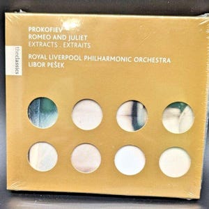 May include: A sealed CD case with a gold cover featuring the text "PROKOFIEV ROMEO AND JULIET EXTRACTS. EXTRAITS" and the Royal Liverpool Philharmonic Orchestra. The cover has six circular cutouts revealing images.