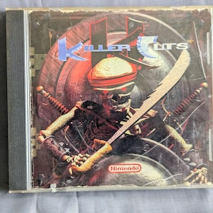 May include: A Killer Instincts 5 video game case. The cover art features a skeletal warrior with a turban, holding a sword. The background includes a shield and swords. The Nintendo logo is visible.