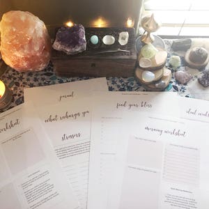 May include: A set of printable worksheets designed for self-care and wellbeing. The worksheets feature titles such as "Daily Recap Worksheet", "What Recharges You", "Stressors", "Find Your Bliss", "Morning Worksheet", and "Ideal Weekly Schedule".