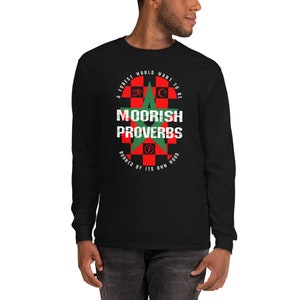 May include: Black long-sleeve t-shirt with a red and green star design. The design includes the text "Moorish Proverbs" and the phrase "A forest would want to be burned by its own wood".