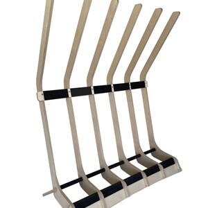 Puede incluir: Un soporte para tablas de surf de madera con seis ranuras para guardar tablas de surf. El soporte est&aacute; hecho de madera clara con acolchado negro en las ranuras. El soporte es independiente y tiene un dise&ntilde;o curvo.
