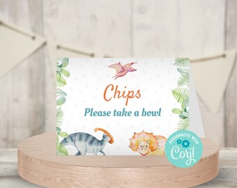 May include: A printable dinosaur-themed food sign with green leaves and white polka dots. The sign says "Chips Please take a bowl".