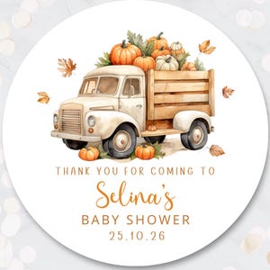 May include: A round sticker featuring a watercolour illustration of a cream-coloured vintage truck carrying pumpkins, with falling autumn leaves. Text reads: THANK YOU FOR COMING TO Selina's BABY SHOWER 25.10.26. The design uses orange and brown tones.