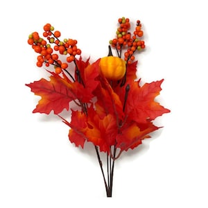 May include: A seasonal arrangement with red and orange maple leaves, orange berries, and a small pumpkin. The leaves display a gradient effect, shifting from red to orange. The arrangement is set against a white background.