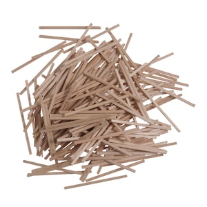 May include: A collection of small, rectangular wooden craft sticks. The sticks are a light brown colour and are scattered randomly against a white background. These craft sticks are suitable for various DIY projects and crafts.