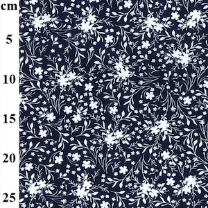 May include: White floral print on a dark blue fabric. The fabric has a small-scale floral pattern with white flowers and leaves on a dark blue background.