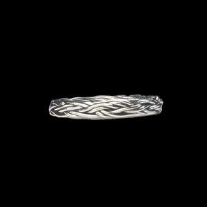 May include: A silver braided ring with a woven design.