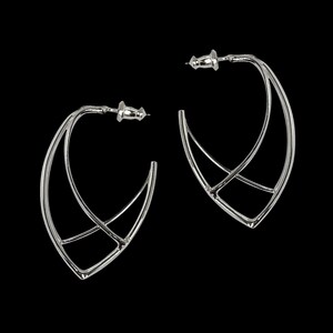 May include: A pair of silver-colored hoop earrings with a geometric design. Each earring features a curved, open shape with intersecting lines, creating a modern and minimalist aesthetic. The earrings are set against a black background.