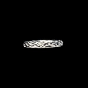 May include: A silver braided ring with a woven design.