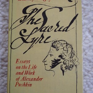 May include: A yellow book cover with the title "The Sacred Lyre" in black cursive script. The author, Dmitry Blagoy, is listed in red text. The book is about essays on the life and work of Alexander Pushkin.
