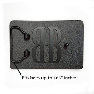 May include: Black leather belt buckle with a double "B" monogram. Fits belts up to 1.65 inches wide.