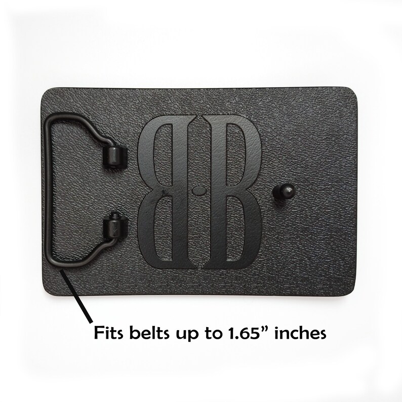 May include: Black leather belt buckle with a double "B" monogram. Fits belts up to 1.65 inches wide.