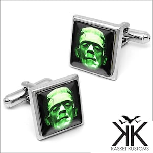 May include: A pair of square cufflinks with a silver finish. Each cufflink features a green image of Frankenstein's monster on a black background. The cufflinks are from Kasket Kustoms.