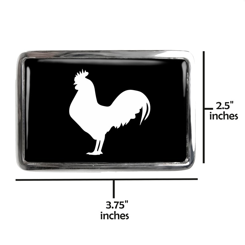 May include: A black and silver belt buckle with a white rooster silhouette. The buckle is 3.75 inches wide and 2.5 inches tall.