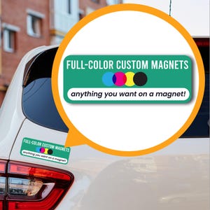May include: A white car with a green and white sticker that says "FULL-COLOR CUSTOM MAGNETS anything you want on a magnet!" The sticker has a small image of four colored circles representing the four colors of printing: cyan, magenta, yellow, and black.