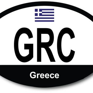 May include: White oval sticker with a black border. The sticker has a blue and white Greek flag, the letters "GRC" in black, and the word "Greece" in black below.