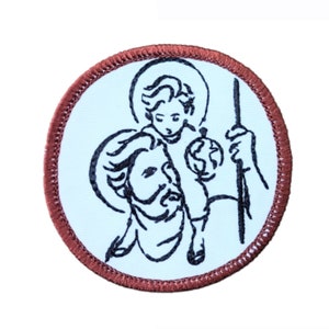 Peut inclure: Un écusson brodé marron avec un fond blanc représentant un dessin au trait noir de Saint Christophe portant un enfant sur son épaule.