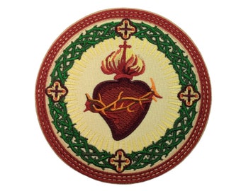 May include: Embroidered patch featuring a red heart with a crown of thorns and flames, surrounded by a green wreath and a red outer circle with four crosses.
