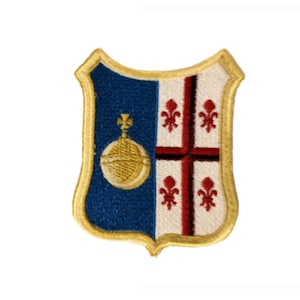 May include: Embroidered patch in a shield shape. The left side is blue with a gold orb and cross design. The right side is white with a red cross and fleur-de-lis symbols. The patch is outlined in gold.